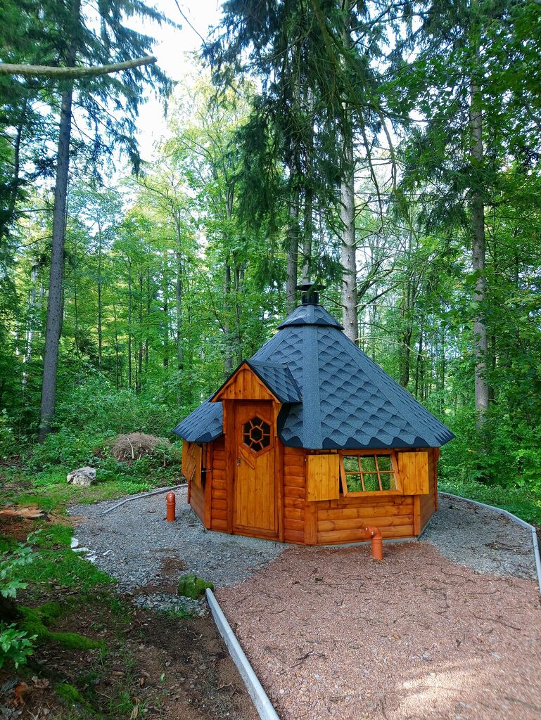 Grillhütte zwischen Bäumen im Garten